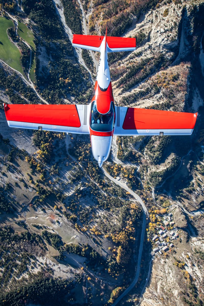 Top-down view of the Bristell B23 Mosaic over an alpine valley