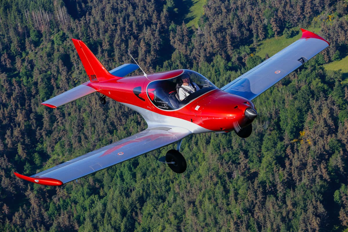 Bristell TDO cruising over forested hills