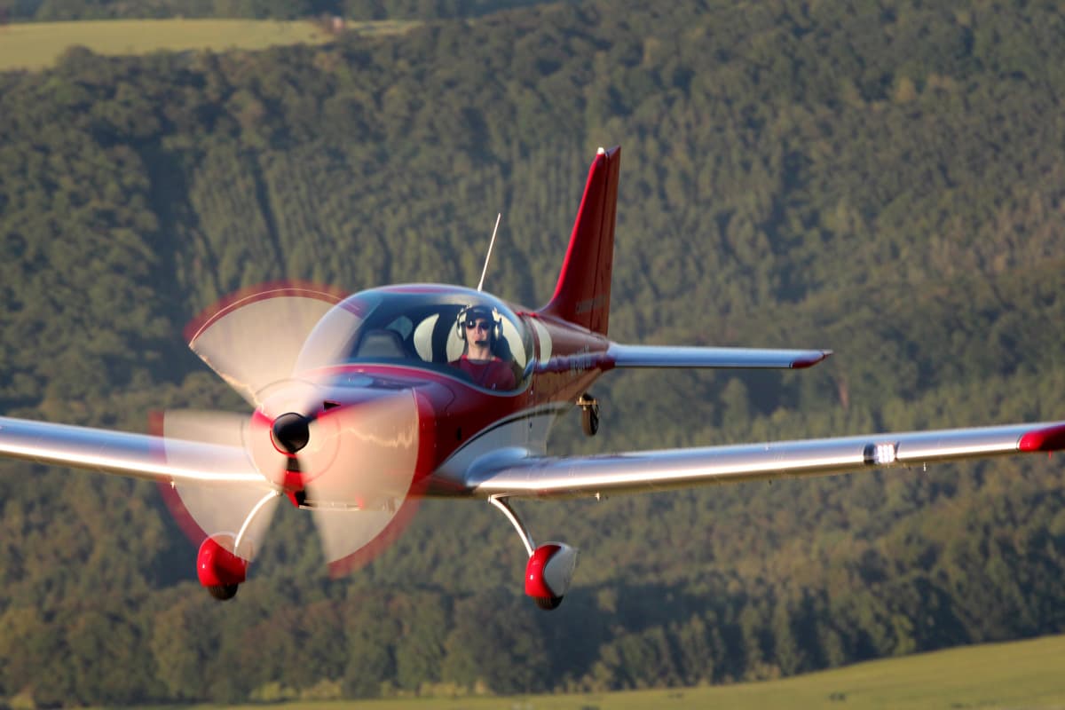 Bristell TDO over forested hills in evening light